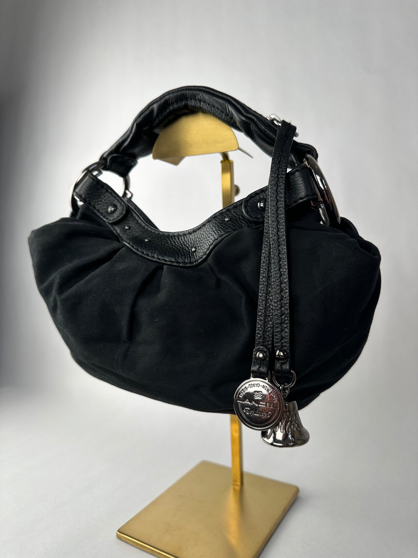 LANCEL small bag in cotton canvas and black grained leather decorated with a bell bag jewel and a signed coin, zipped handle.
