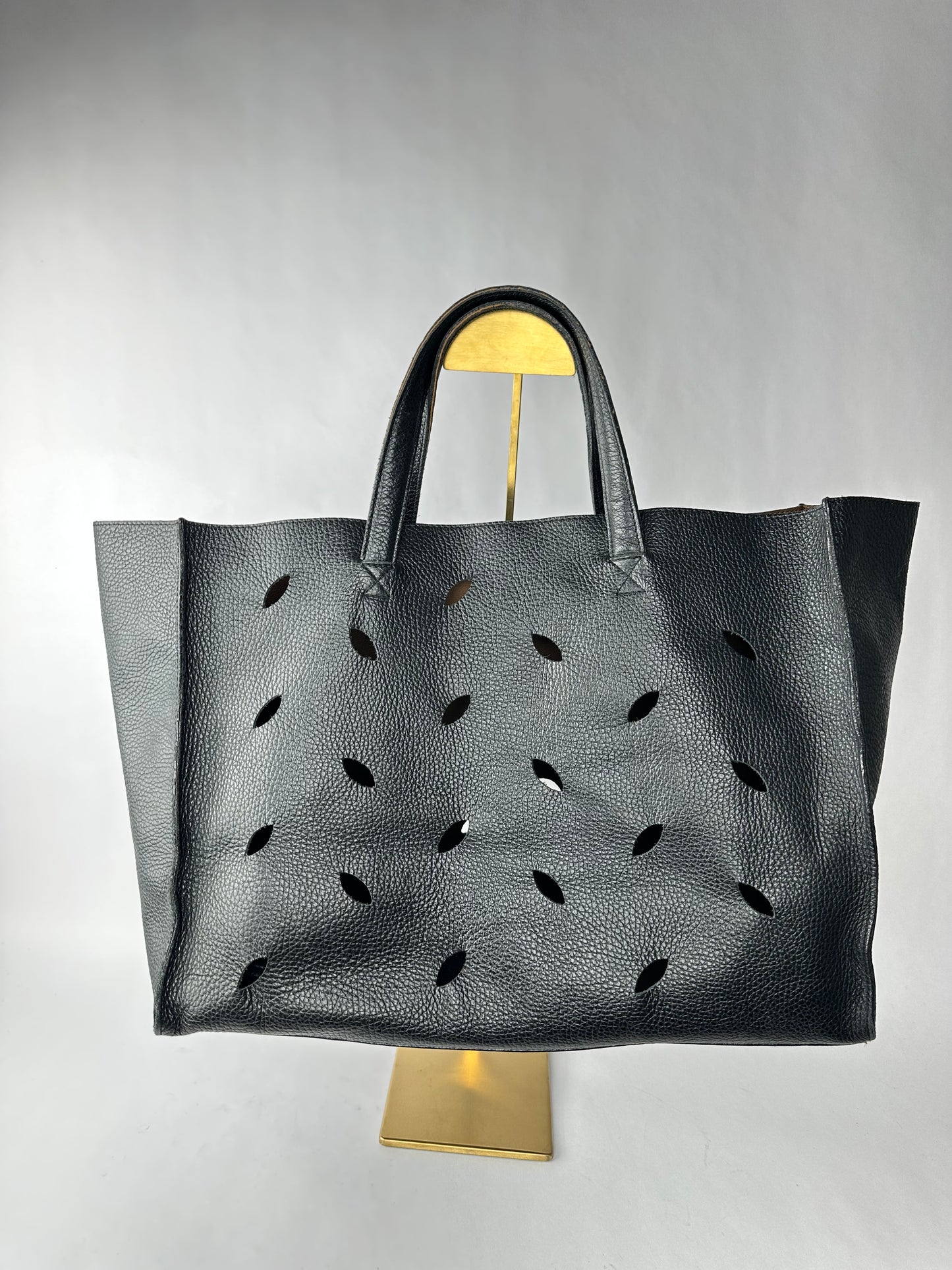 PIERRE HERME bag in black grained cowhide with openwork leaf motifs