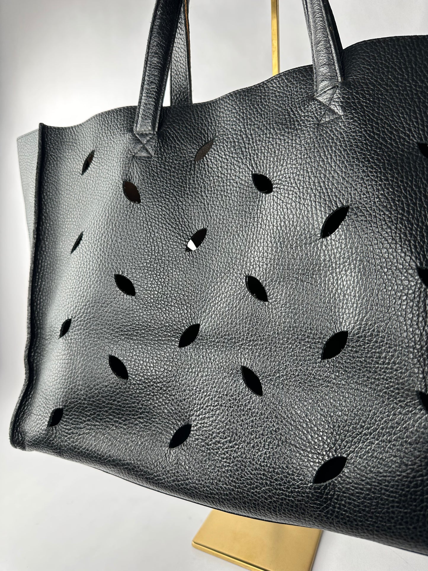 PIERRE HERME bag in black grained cowhide with openwork leaf motifs