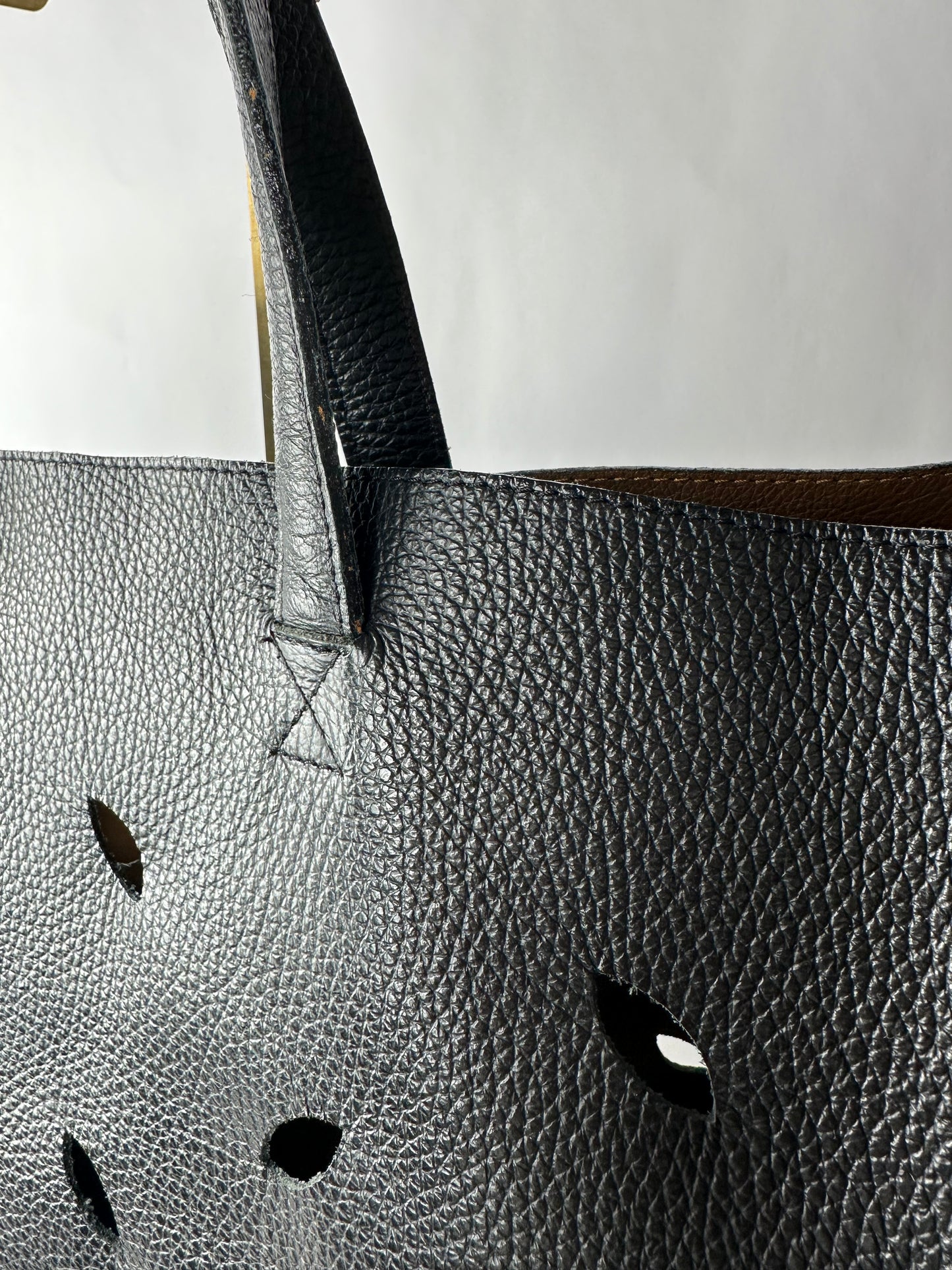 PIERRE HERME bag in black grained cowhide with openwork leaf motifs