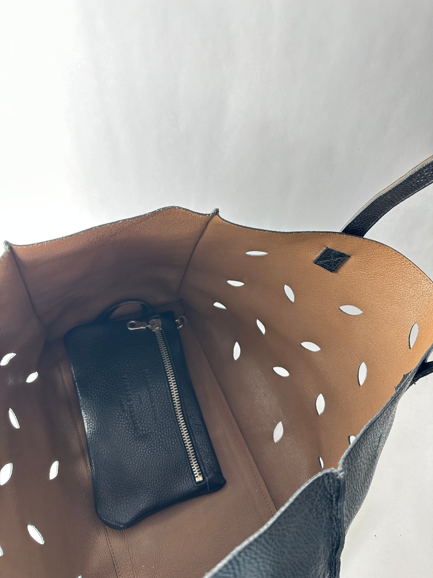 PIERRE HERME bag in black grained cowhide with openwork leaf motifs