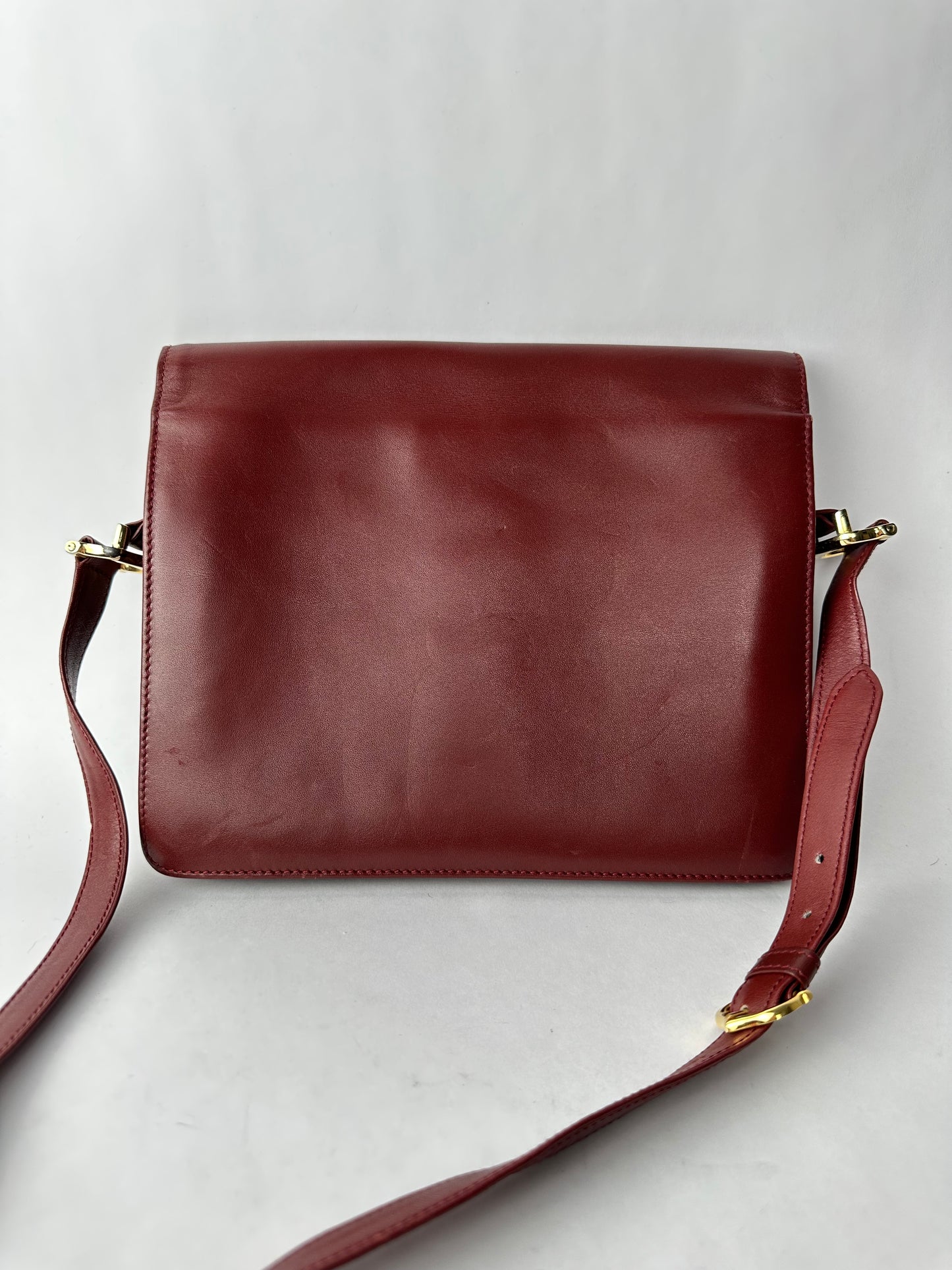 CARTIER Burgundy leather bag with gold details