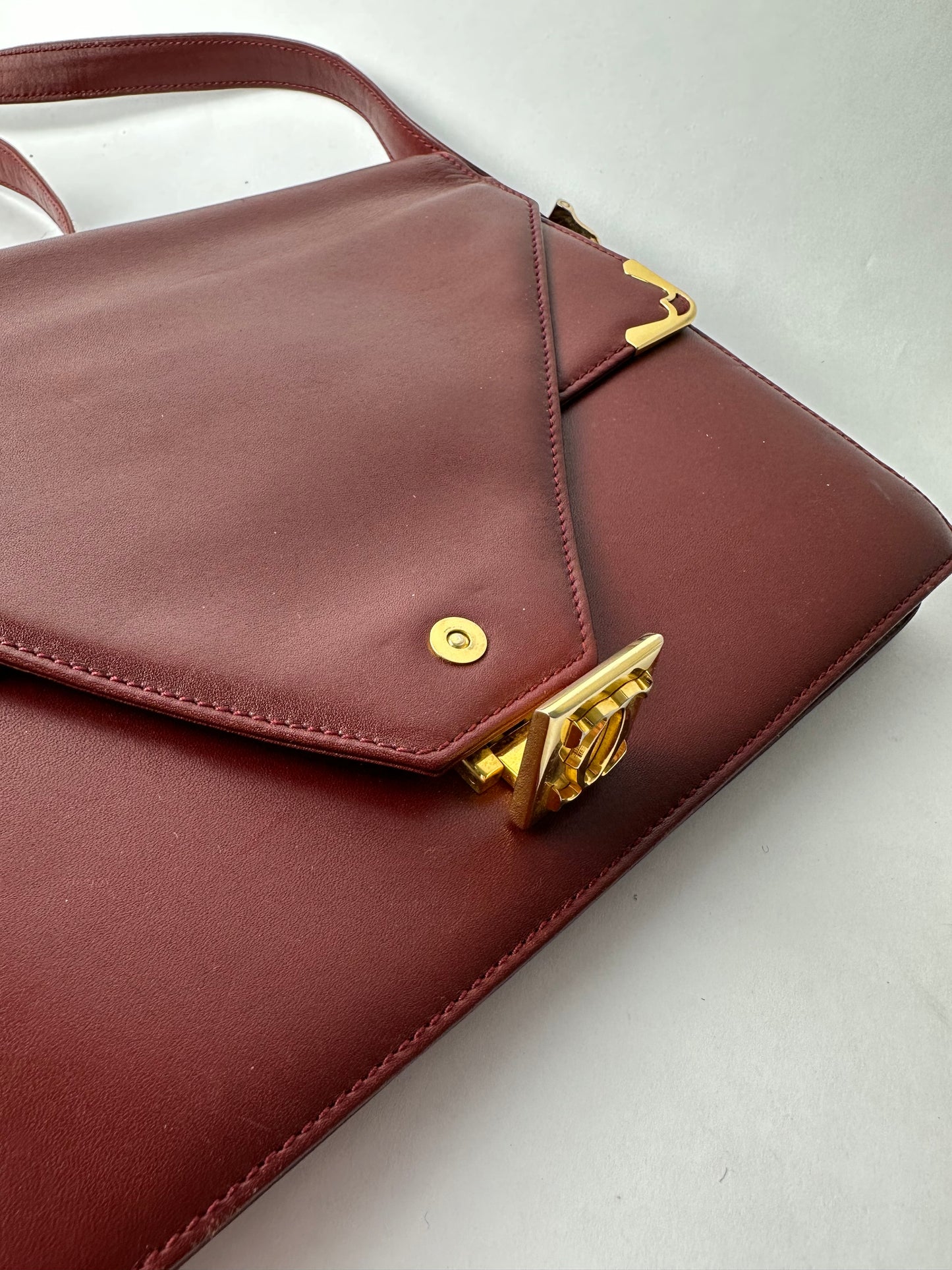 CARTIER Burgundy leather bag with gold details
