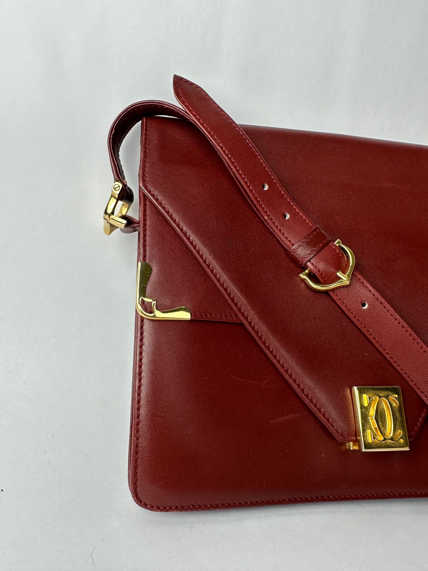 CARTIER Burgundy leather bag with gold details