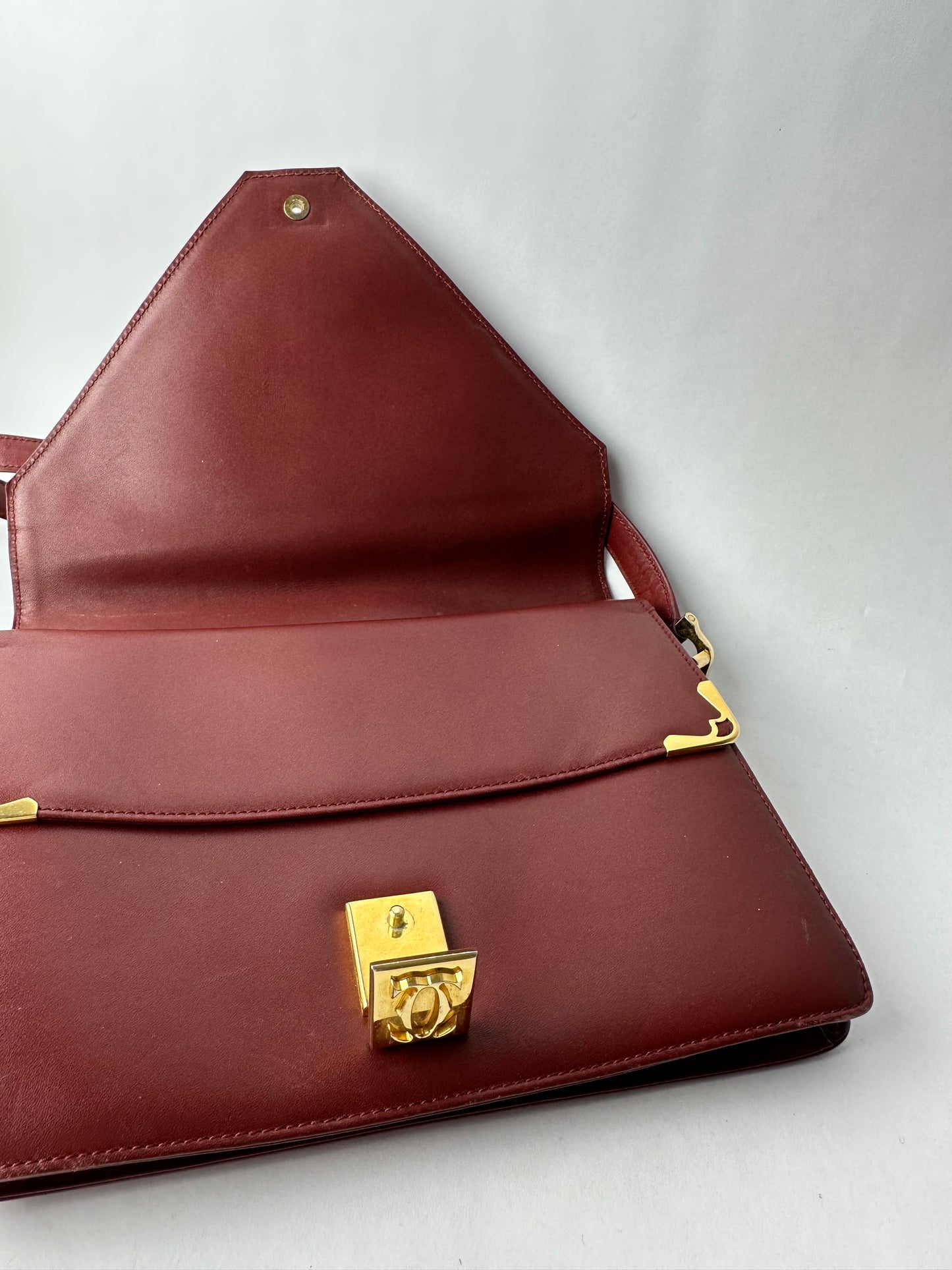 CARTIER Burgundy leather bag with gold details